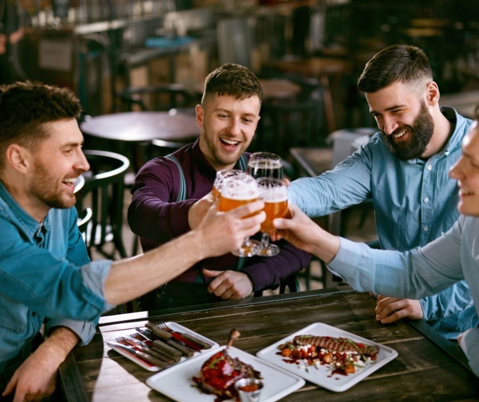 a few buddies enjoying their beer in a gay club